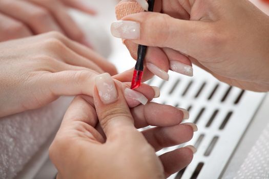 Beautician cutting cutticles on the right hand. Close-up shot