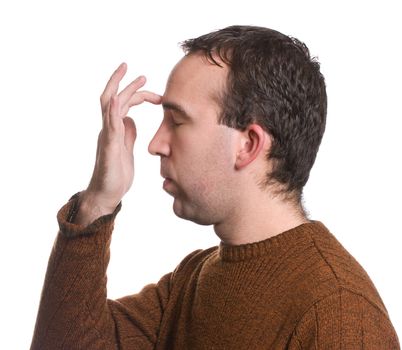 A man wearing a sweater is doing the "emotional freedom technique" by tapping on his forehead, isolated against a white background