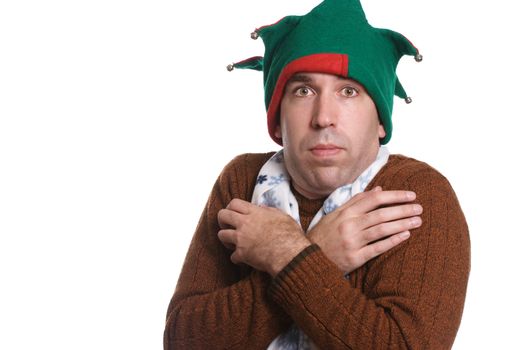 A man is cold and wearing only a sweater, an elf hat and a white scarf, all of which don't match, isolated against a white background