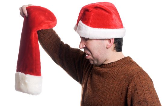 Profile view of a man wearing a Santa hat looking disgusted that his stocking is empty, isolated against a white background