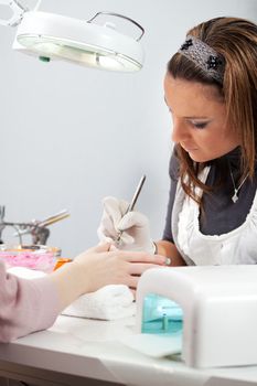 Professinal beautician working on fingernails. Close-up shot
