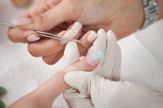 Professional beautician removing airbrush pattern. Close-up shot