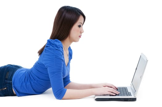 portrait of a casual female student using laptop over white background.