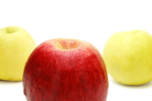 Red Leader Apple in front of Yellow Apples Isolated on White