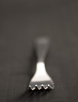 Close up of a fork with DOF black background