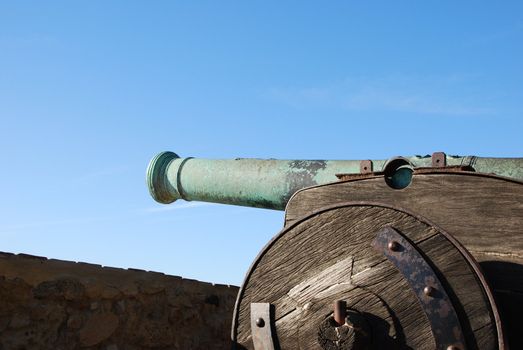 antique iron cannon weapon with blue sky background