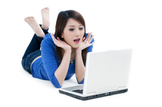 Portrait of a happy young woman using laptop over white background.