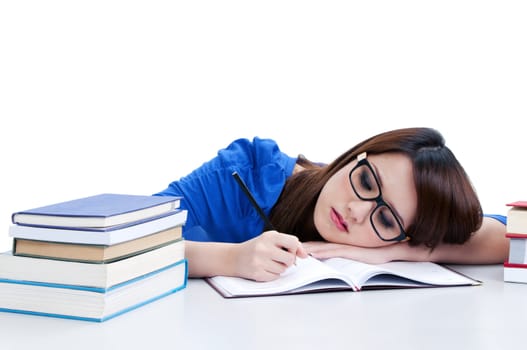 Casual young student writing and head resting on arm, over white background.