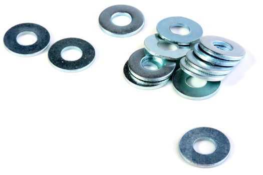 Metal washers for metalwork works on a white background.