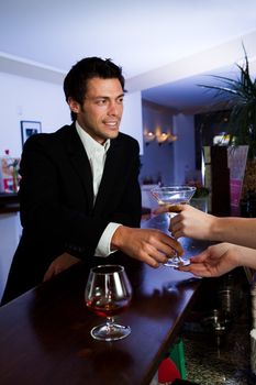 Man ordering martini. Focus on the hands