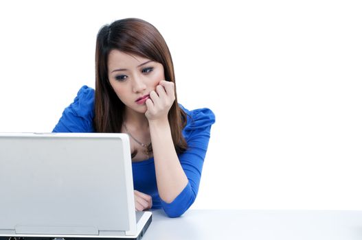 Portrait of a pensive woman using laptop  over white background.