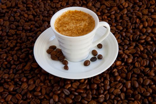 Cup with coffee, costing on coffee grain