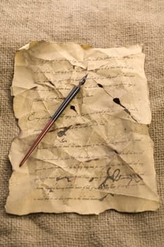 A beautiful old feather on an old letter