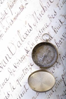 A beautiful golden compass on an old letter