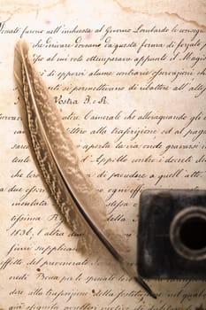 A beautiful old feather on an old letter