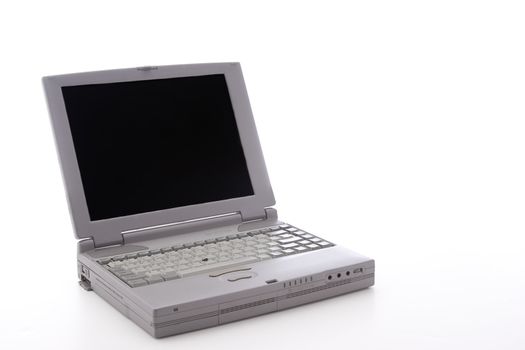 Laptop dating from the 90's, with a port door open, on a white background