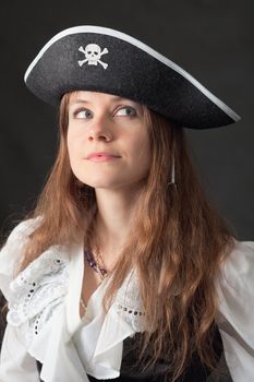 Art portrait of the beautiful woman in an ancient piracy hat