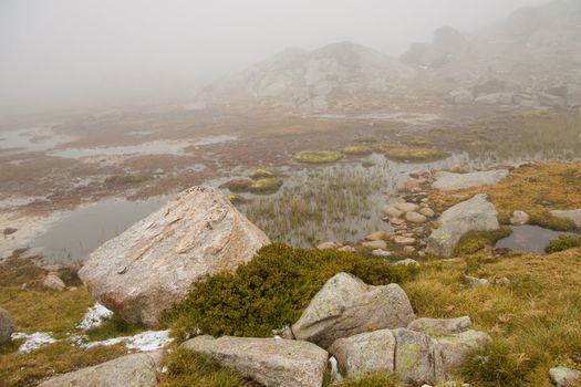 Foggy day in Andorra, Pyrenees. Small lake and gray day.