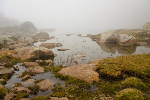 Foggy day, small lake in Andorra - Pyrenees.