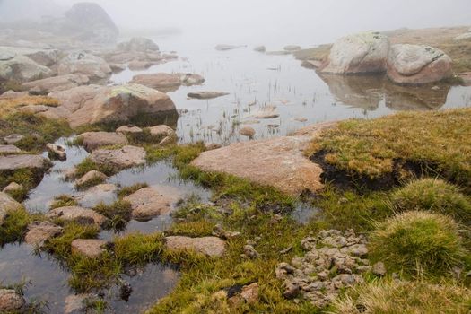 View on lake in foggy day in Pyrenees mountain - Andorra.