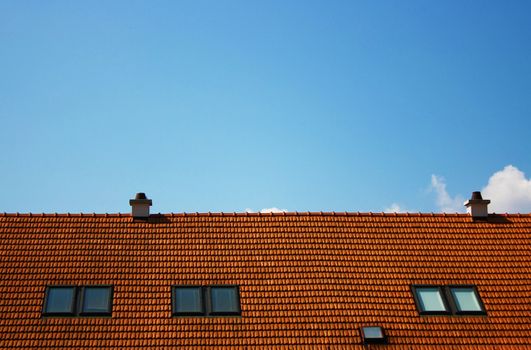 Rooftop of an apartment building and blue sky background.
