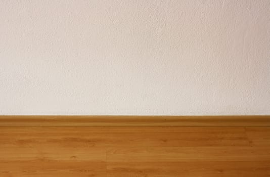 Hardwood floor and white wall background.