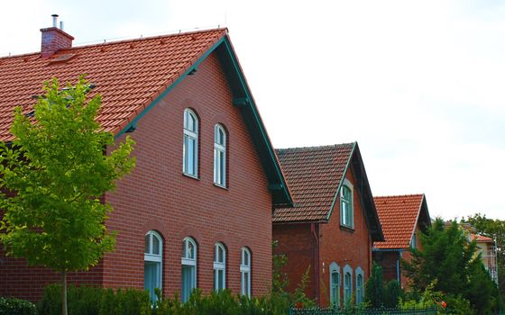 Row of identical houses for sale in a residential area.