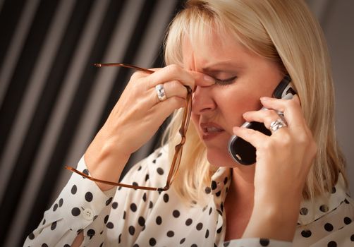 Blonde Woman on Her Cell Phone with Stressed Look on Her Face.