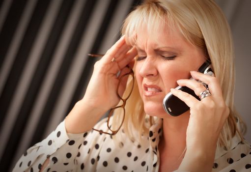 Blonde Woman on Her Cell Phone with Stressed Look on Her Face.