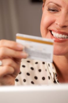 Beautiful Woman on Her Laptop Holding Her Credit Card.