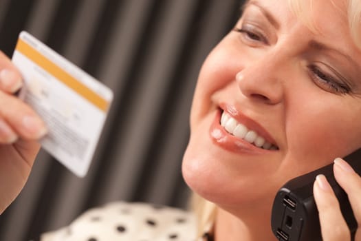 Beautiful Woman on the Phone Holding Her Credit Card.