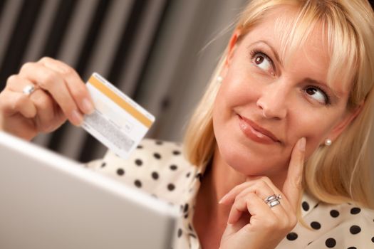 Beautiful Woman on Her Laptop Holding Her Credit Card.