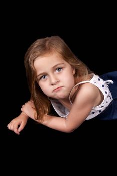 Unhappy young girl isolated on black background