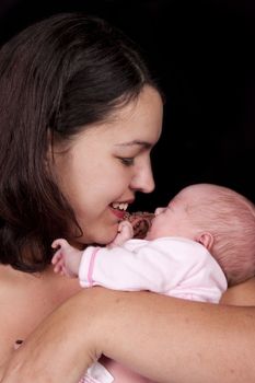 Mother and eight day old baby isolated on black