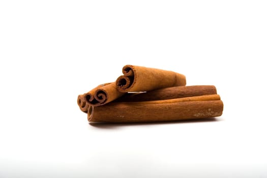 A few dry sticks of cinnamon on a white background