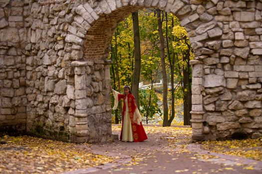 lady in medieval red dress standing in doorway
