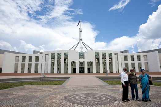 Three tourists discuss something in front of Parliament House, Canberra, 2011.