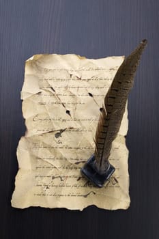 A beautiful old feather on an old letter