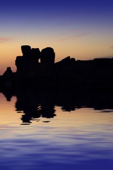 The oldest free-standing building/temple in the world. Oldest neolithic prehistoric temple built thousands of years before the pyramids. - Hagar Qim & Mnajdra Temples in Malta, Mediterranean Sea, Europe - here seen silhouetted at sunset