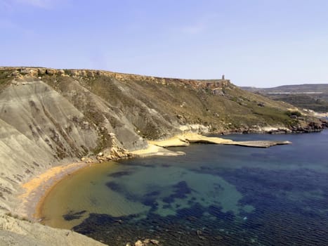 Typical rocky coastline in Malta, punctuated with sheer drops and jagged cliffs