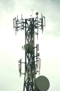 cellular communication tower on a cloudy day
