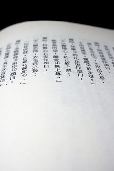 Close-up of a Chinese Buddhist Sutra on black background.