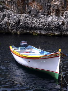 Colorful Fishing boat moored in a valley in Malta