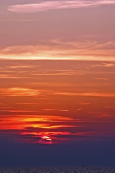 Sun setting over the sea with clouds