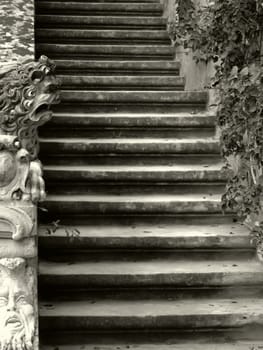 Imposing medieval stone sculpture of lion, guarding palace staircase.