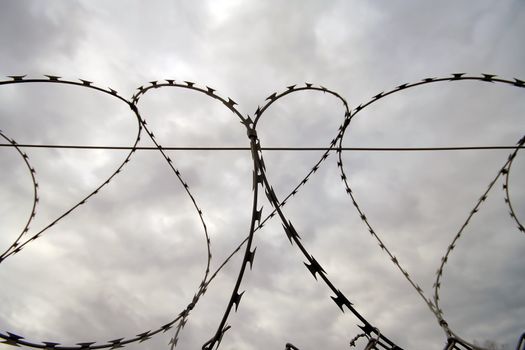 Wired fence with cloudy sky