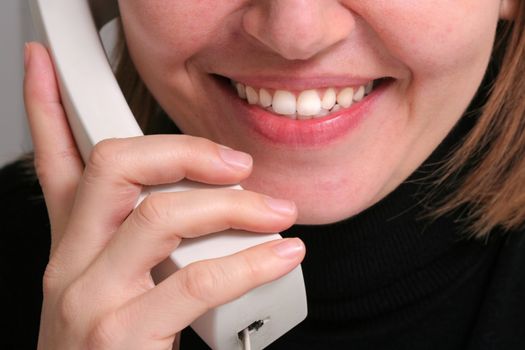 Woman talking on telephone and smiling