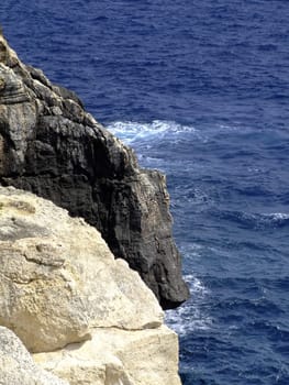 Typical rocky coastline in Malta, punctuated with sheer drops and jagged cliffs