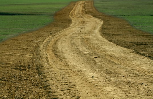 A rural unpaved sinuous road
