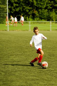 a young boy is playing soccer